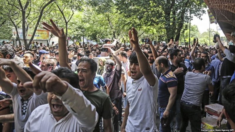 A group of protesters chant slogans at the old Grand Bazaar in Teheran, Iran, Monday, June 25, 2018