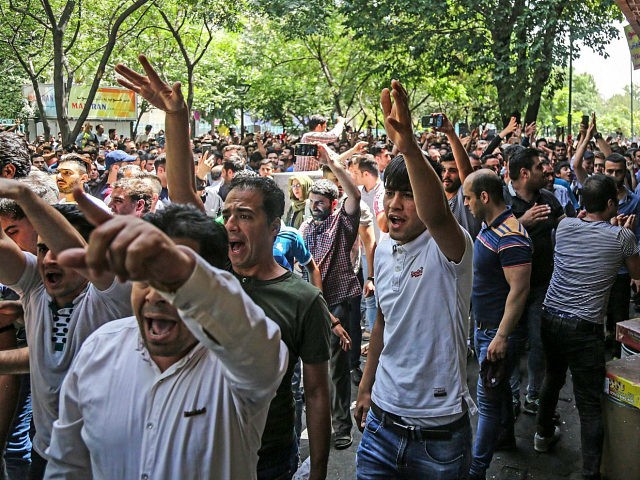 Iranians protesting outside a bazaar.