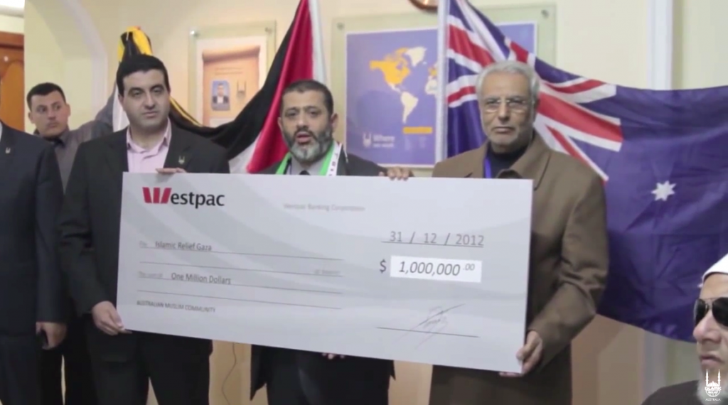 Islamic Relief Australia delegation in Gaza presenting a cheque for $1 million to Islamic Relief Gaza (YouTube screenshot)