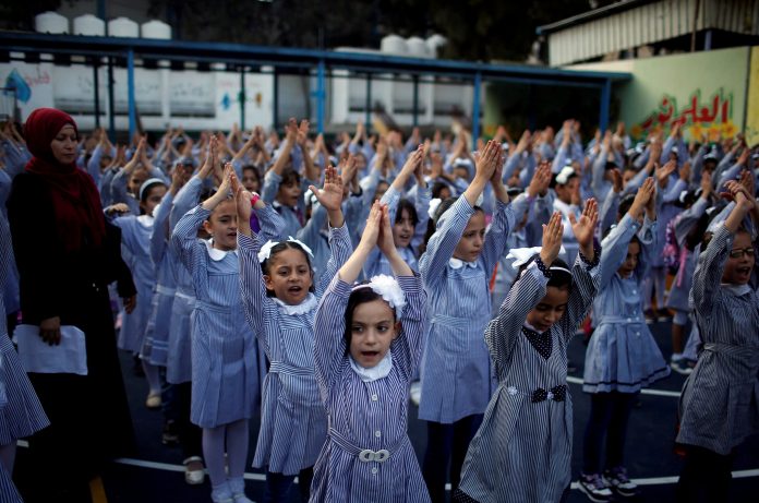 Image: Palestinian Schoolgirls Participate In The Morning Exercise At An UNRWA Run School On The First Day Of A New School Year, In Gaza City