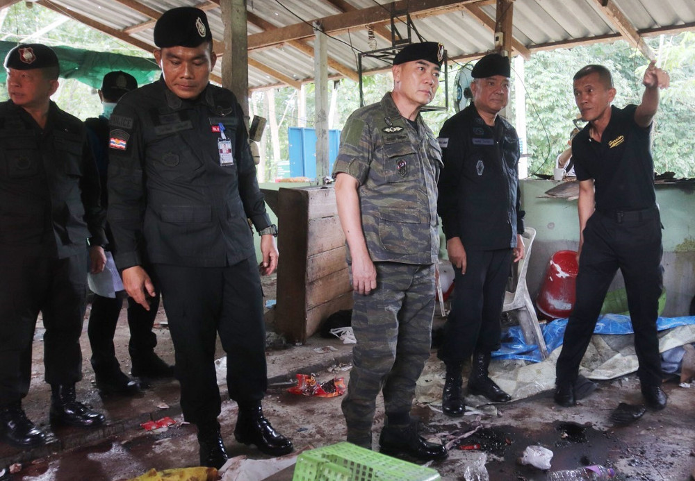 Thai National Police Chief Chakthip Chaijinda (centre) inspects one of two village defence outposts where 15 people were killed in attacks by insurgents in Thailand’s Deep South