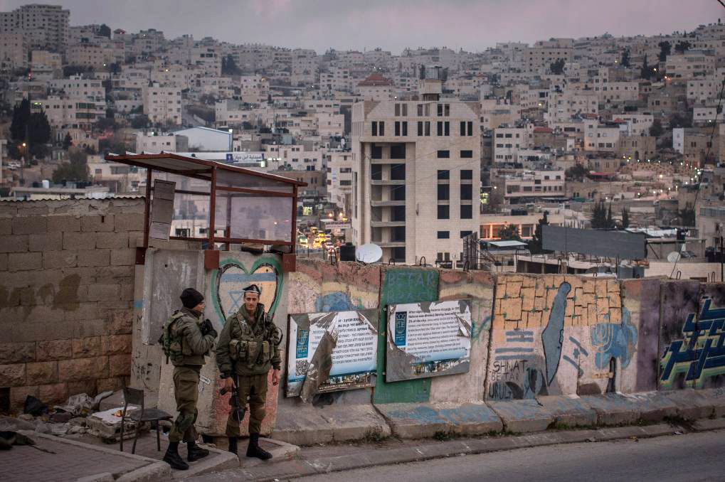 Israeli soldiers man a checkpoint to an Israeli settlement in Hebron in the West Bank. Picture: Getty Images