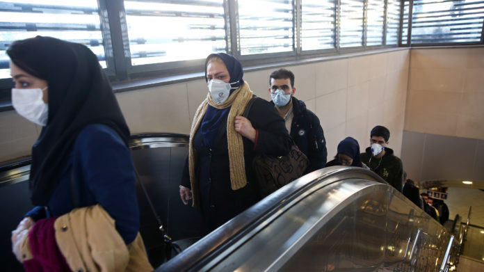 Iranian People Wear Protective Masks To Prevent Contracting A Coronavirus, As They Climb An Escalator In Tehran