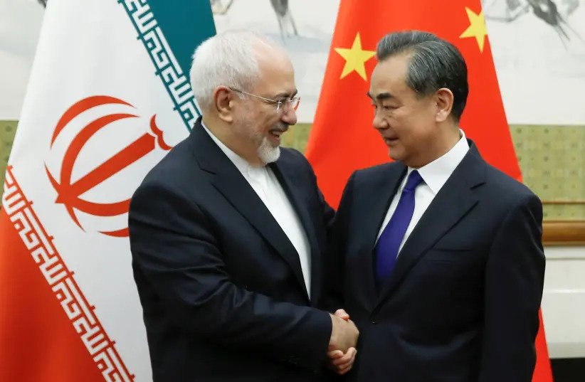 Chinese State Councillor and Foreign Minister Wang Yi meets Iranian Foreign Minister Mohammad Javad Zarif at Diaoyutai state guesthouse in Beijing, China May 13, 2018 (photo credit: THOMAS PETER/REUTERS).
