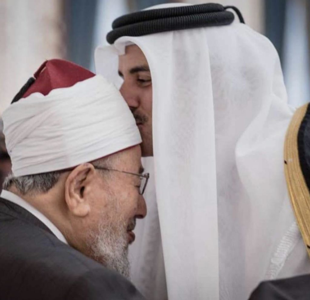 Qatari Emir Sheikh Tamim bin Hamad Al-Thani (Right) kisses Yusuf Al-Qaradawi, an extremist Al-Jazeera host and "spiritual leader" for Hamas and the Muslim Brotherhood