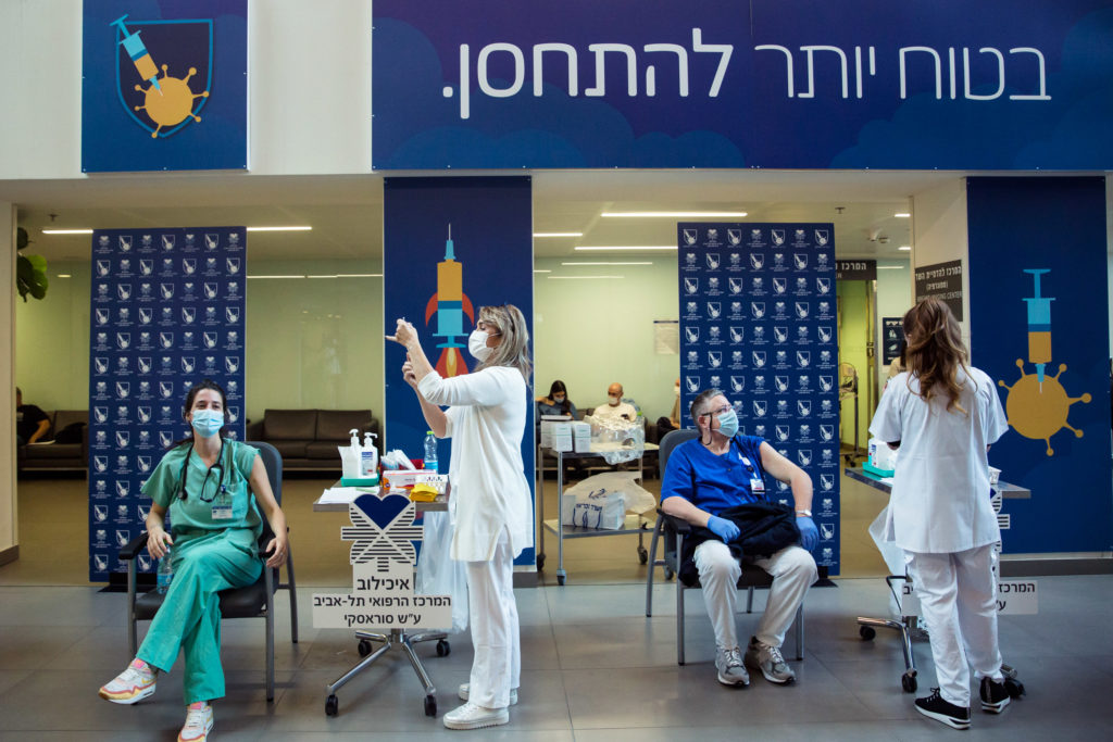 Medical workers vaccinate medical stuff members against Coronavirus disease(COVID-19) at Tel Aviv Sourasky Medical Center (Photo by Amir Levy/Getty Images)