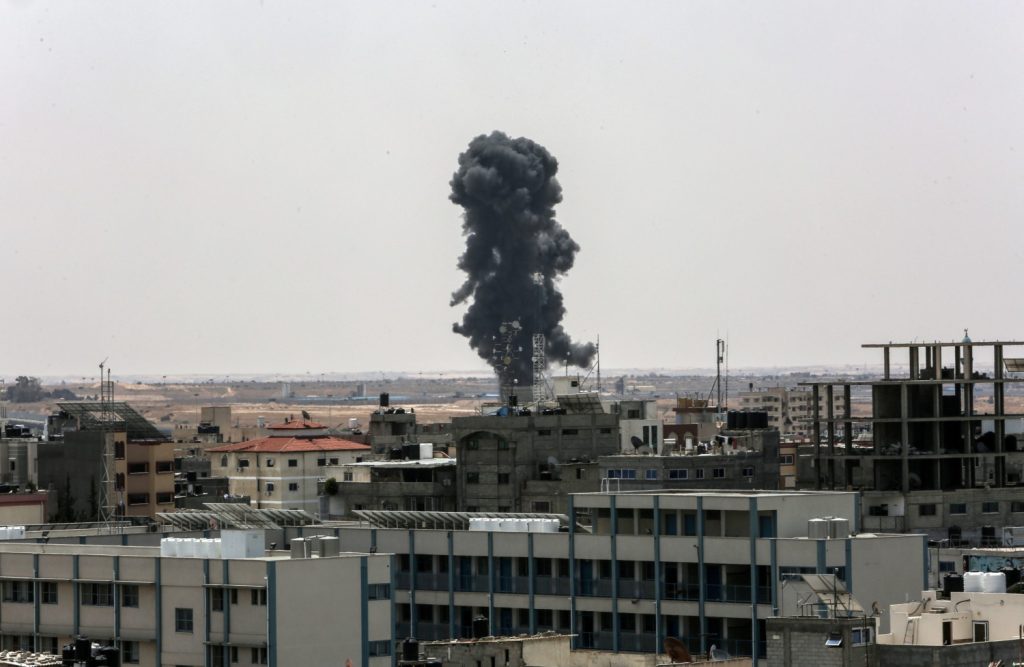 Smoke rises above buildings after air strikes by Israeli warplanes, in the southern Gaza Strip, on May 12, 2023 (Image: Shutterstock)