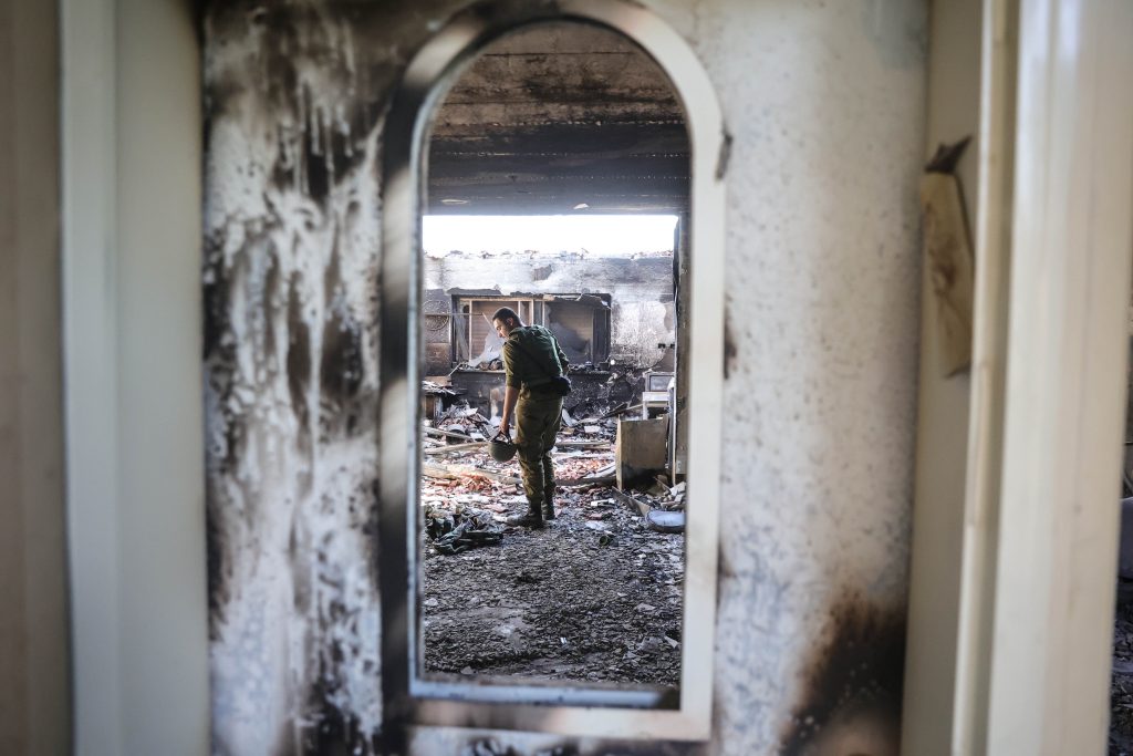 An Israeli soldier inside the rubble of a house in Kibbutz Be’eri, near the border with Gaza, where at least 130 Kibbutz members were killed by Hamas in its attack against Israel from the Gaza Strip on October 7. (Image: AAP/ Abir Sultan)