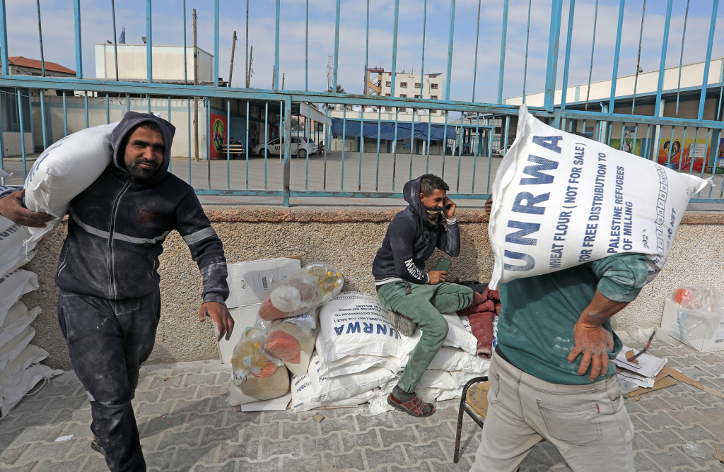 Palestinians receive their food rations from the United Nations Relief and Works Agency (UNRWA) warehouse in the southern Gaza Strip town of Rafah (Image: Shutterstock)