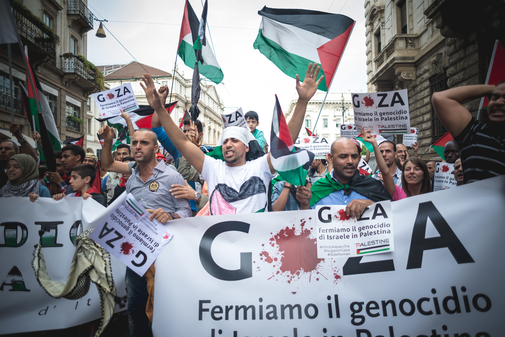 Pro-Palestinian rally in Milan, Italy, with signs promoting the lie that Israel is committing genocide in Gaza (source: Eugenio Marongiu/Shutterstock)