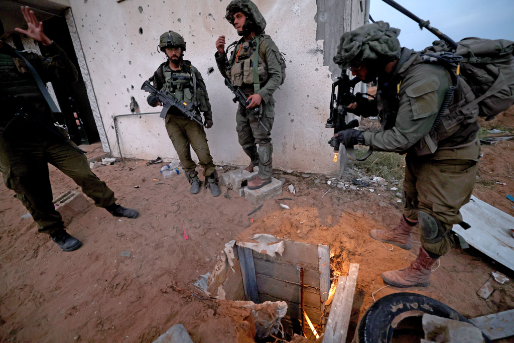 Israeli soldiers standing next to the entrance to a tunnel in the Palestinian refugee camp of Jabalia, on the outskirts of Gaza City, northern Gaza Strip, December 8, 2023 (Image: Atef Safadi/EPA/AAP)