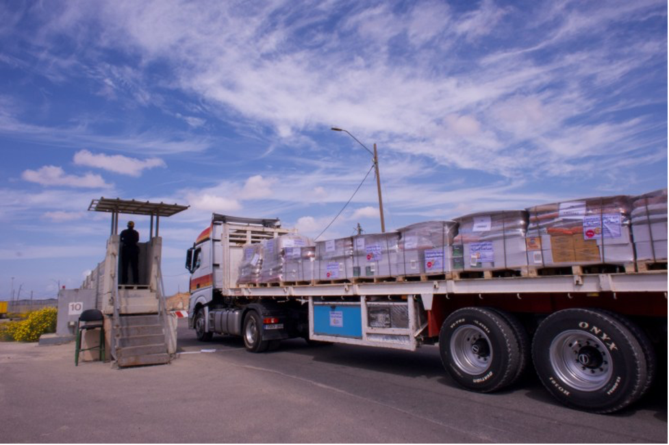 A truck carrying food and other humanitarian aid moves through a security checkpoint at Kerem Shalom, Israel, into the Gaza Strip on March 14 (Image: Charlotte Lawson)