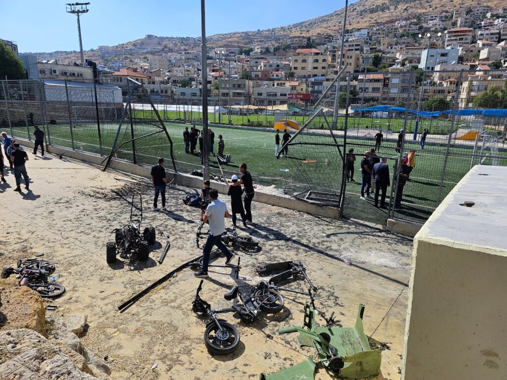 Aftermath of Hezbollah rocket fire attack on a school playground in a druze town of Majdal Shams, 29 July 2024 (Image: Roman Yanushevsky/ Shutterstock)