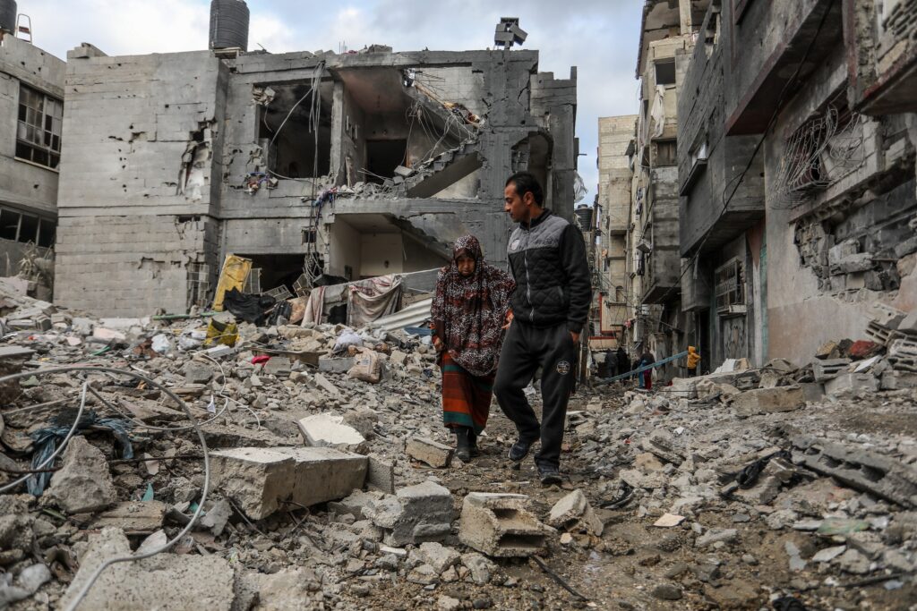 Palestinians inspect their destroyed house after an Israeli air strike in the city of Rafah in the southern Gaza Strip (Image: Anas Mohammed/ Shutterstock)