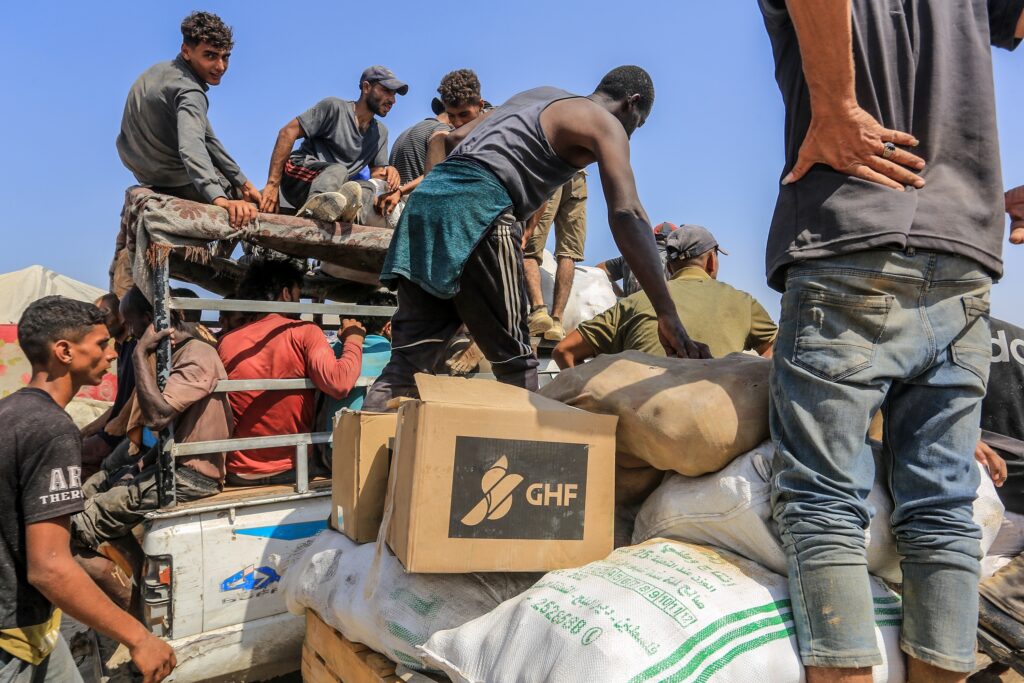 Palestinians receive humanitarian and food aid from the American Center for Humanitarian Aid (GHF), located in Rafah, Gaza Strip, on August 2025 (Image: Shutterstock)