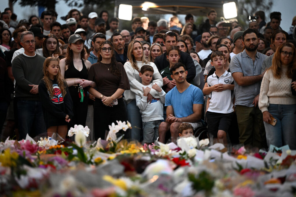 Mourners attend a vigil at a memorial in Bondi Beach in Sydney, December 15, 2025, after gunmen opened fire on Bondi Beach, killing 15 people in an attack targeting the Jewish community (Image: AAP Image/ Bianca De Marchi) 