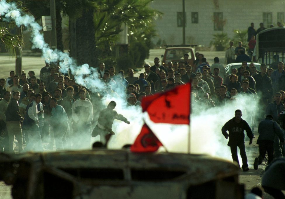 Palestinians shoot tear gas at the Israeli army in Ramallah, as  they clash during the first days of the Second Intifada. The intifada was the second Palestinian uprising, a period of intensified Palestinian-Israeli violence, which began in late September 2000. October 24, 2000. Photo by Nati Shohat/Flash90