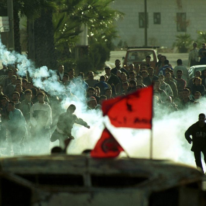 Palestinians shoot tear gas at the Israeli army in Ramallah, as  they clash during the first days of the Second Intifada. The intifada was the second Palestinian uprising, a period of intensified Palestinian-Israeli violence, which began in late September 2000. October 24, 2000. Photo by Nati Shohat/Flash90