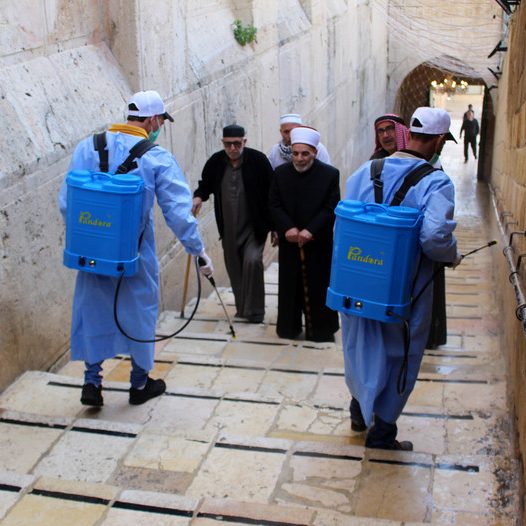 Palestinian workers disinfect gates and barriers near the near the Ibrahimi mosque in the Old city of the West Bank city of Hebron as a preventive measure amid fears of the spread of the novel coronavirus, on March 11, 2020. Photo: Mosab Shawer