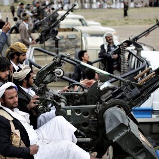 Houthi rebel fighters ride on trucks mounted with weapons during a gathering in Sanaa, Yemen. (AP Photo/Hani Mohammed)