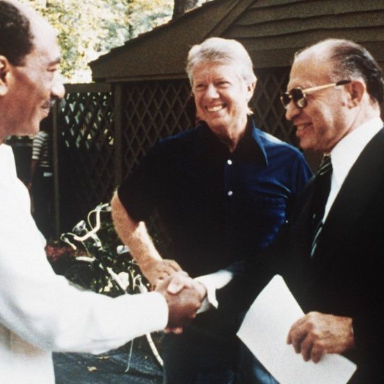 This file photo shows former Egyptian President Anwar al-Sadat (L) as he shakes hands with former Israeli Premier Menachem Begin, as former US President Jimmy Carter looks on, 06 September 1978 at Camp David, the US presidential retreat in Maryland.  (AFP/Getty Images)