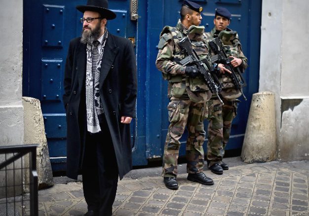 Armed soldiers patrol outside a school in the Jewish quarter of Paris