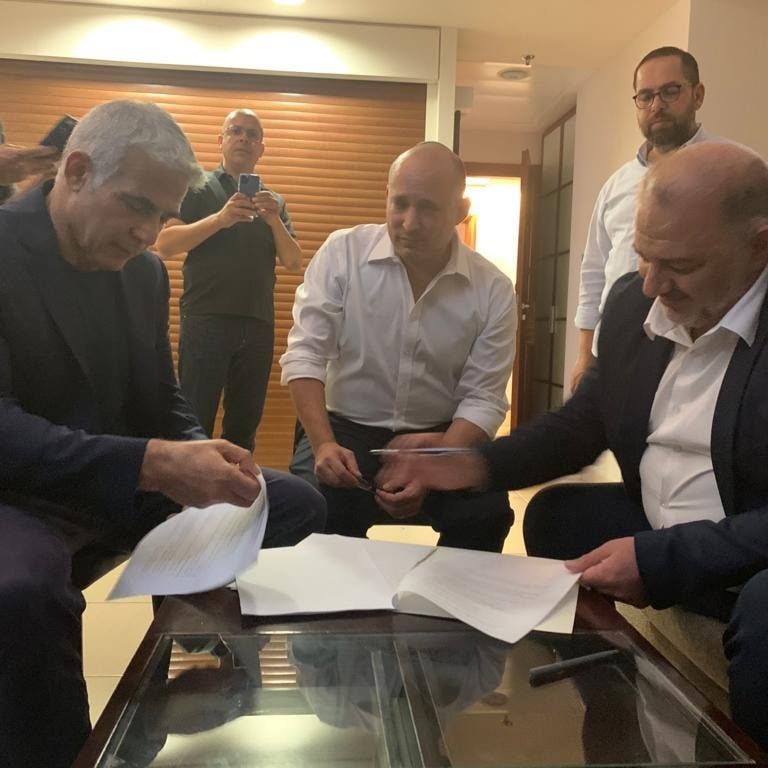 Yair Lapid, Naftali Bennett and Mansour Abbas agree on terms for adding the Muslim-Arab Ra'am party to the coalition.