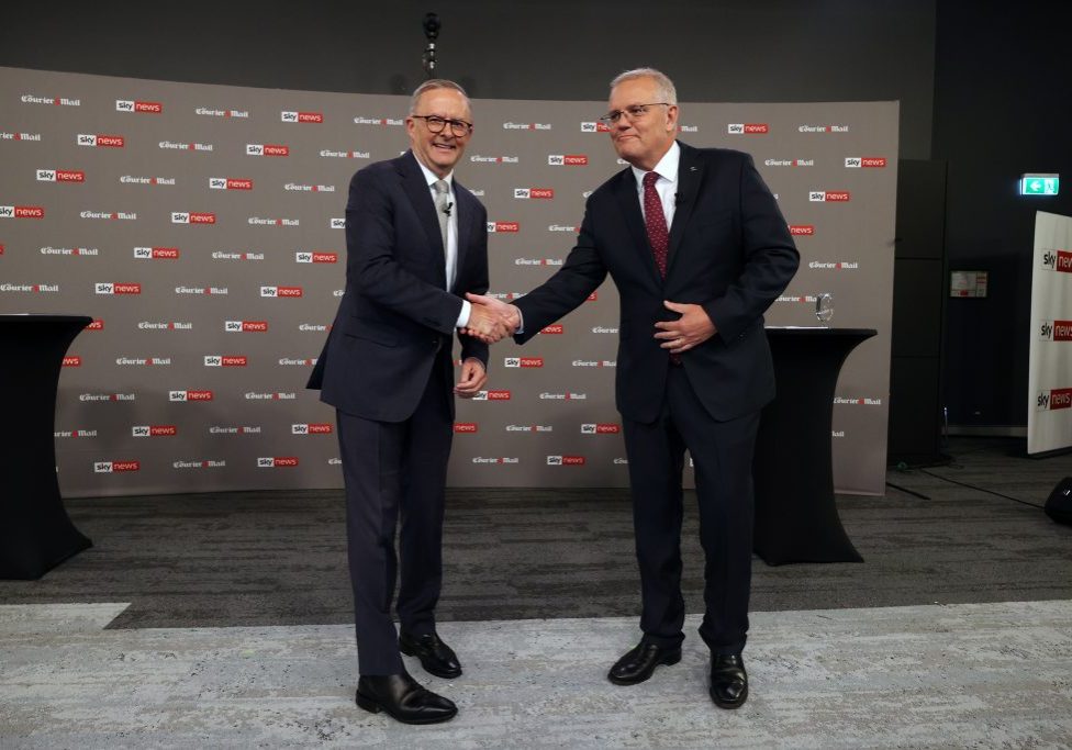 Prime Minister Scott Morrison (right) shakes hands with Opposition Leader Anthony Albanese during the first leaders' debate of the 2022 federal election in Brisbane, Wednesday, April 20, 2022. (AAP Image/Pool, Jason Edwards)