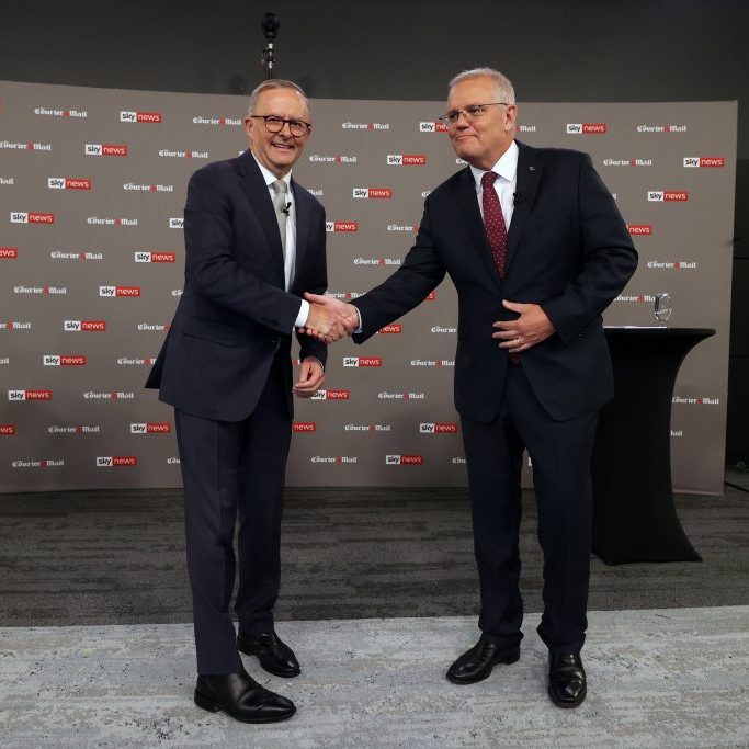 Prime Minister Scott Morrison (right) shakes hands with Opposition Leader Anthony Albanese during the first leaders' debate of the 2022 federal election in Brisbane, Wednesday, April 20, 2022. (AAP Image/Pool, Jason Edwards)