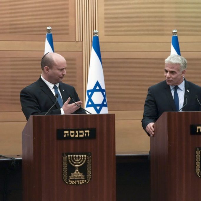 Israeli Prime Minister Naftali Bennett, left, speaks during a joint statement with Foreign Minister Yair Lapid, at the Knesset, Israel's parliament, in Jerusalem, Monday, June 20, 2022.  (AP Photo/Maya Alleruzzo)