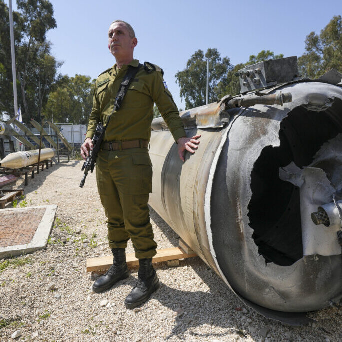 Israeli military spokesperson Rear Adm. Daniel Hagari displays to the media one of the Iranian ballistic missiles Israel intercepted on April 14, in Julis army base, southern Israel, April 16, 2024 (Image: AAP/Tsafrir Abayov)