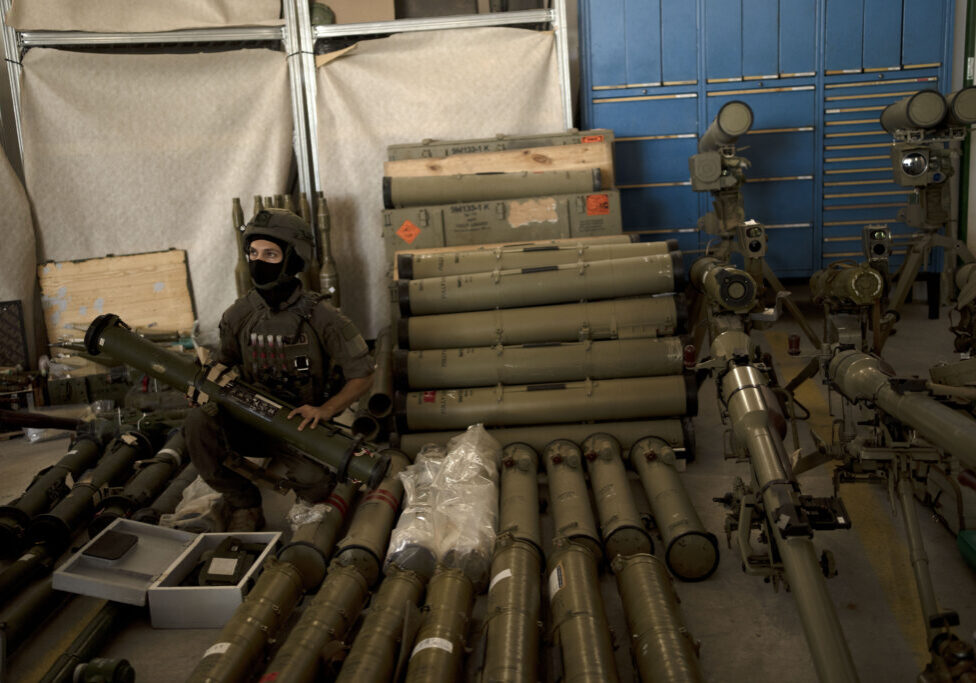 An Israeli soldier from an EOD (explosive ordnance disposal) unit poses with a weapon used by Hezbollah seized during combat operations in Lebanon at a base in southern Israel, Oct. 9, 2024. (Image: AP Photo/Maya Alleruzzo)