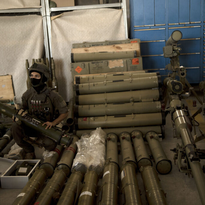 An Israeli soldier from an EOD (explosive ordnance disposal) unit poses with a weapon used by Hezbollah seized during combat operations in Lebanon at a base in southern Israel, Oct. 9, 2024. (Image: AP Photo/Maya Alleruzzo)