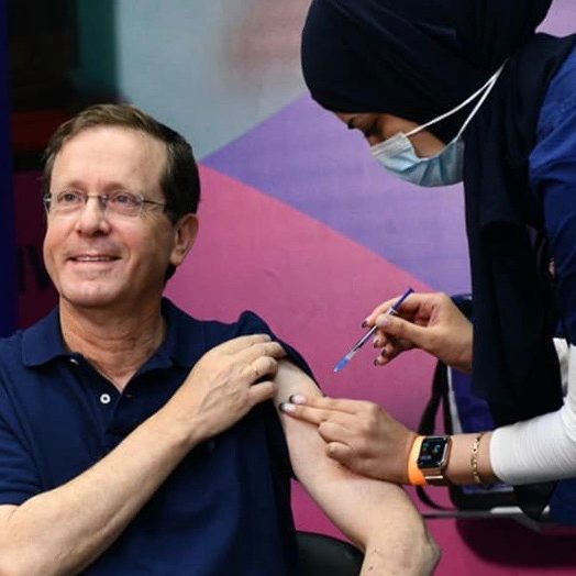 Israel's President Isaac Herzog receives a booster vaccination. (Credit: GPO)