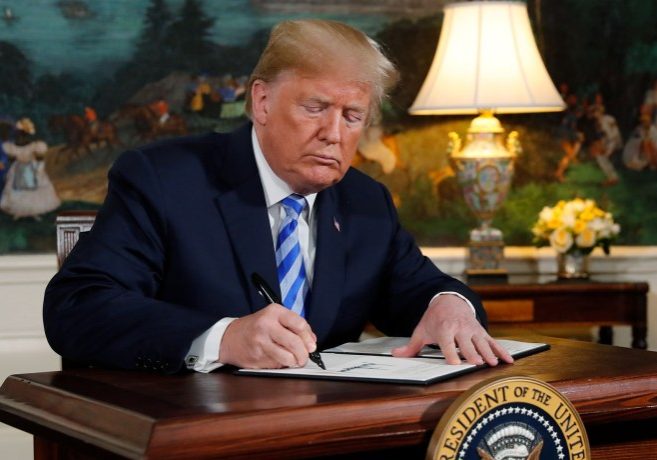 U.S. President Donald Trump signs a proclamation declaring his intention to withdraw from the JCPOA Iran nuclear agreement in the Diplomatic Room at the White House in Washington, U.S., May 8, 2018. REUTERS/Jonathan Ernst