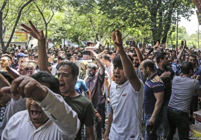 A group of protesters chant slogans at the old Grand Bazaar in Teheran, Iran, Monday, June 25, 2018