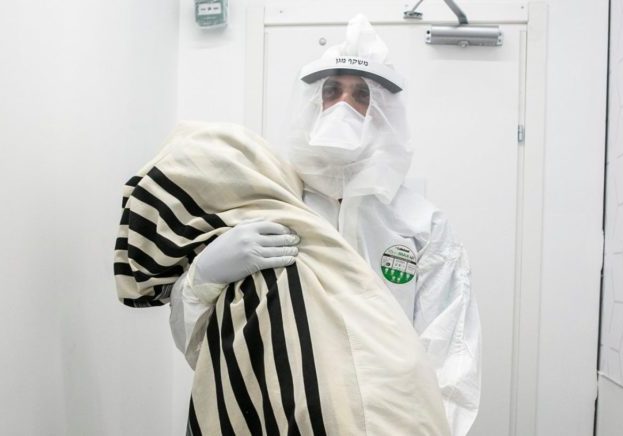 Dr. Abed Zahalka bringing a Torah scroll into the coronavirus unit at Mayanei Hayeshua Medical Centre in Bnei Brak