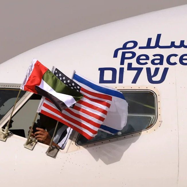 

The Emirati, U.S. and Israeli flags are pictured attached to an airplane of Israel's El Al upon its arrival at the Abu Dhabi airport in the first commercial flight from Israel to the United Arab Emirates on Aug. 31. (Karim Sahib/AFP/Getty Images)