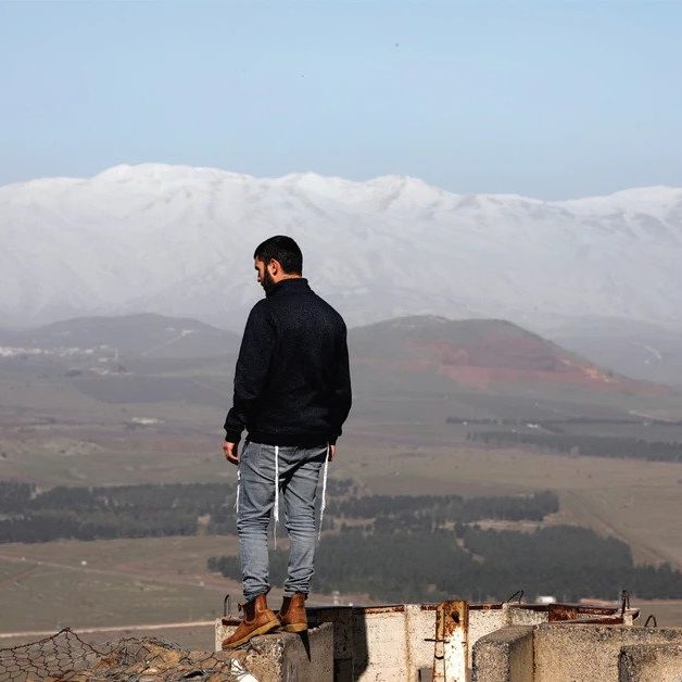 A man stands at Mount Bental, an observation post on the Golan Heights that overlooks the Syrian side of the Quneitra crossing, on January 21. (photo: REUTERS)