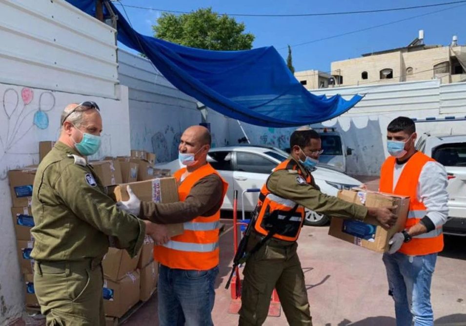 Israeli soldiers and Palestinian volunteers work together to deliver food and medical supplies in east Jerusalem