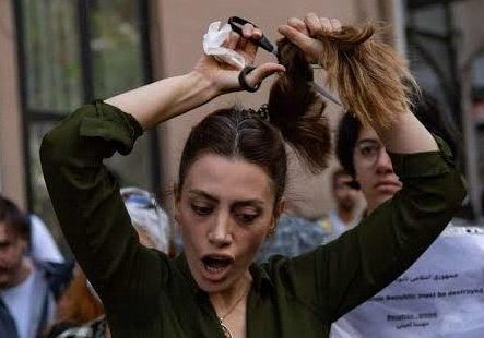A protester cuts her hair: Iranian women have actually been resistiing mandatory Hijab laws since 1979 (Image: Twitter)