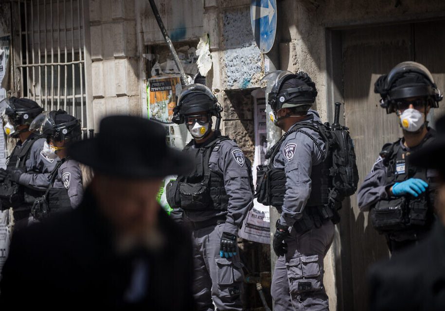 Israeli police officers seen during a raid on the ultra orthodox Jewish neighborhood of Meah Shearim, as they close shops and disperse public gatherings following the government decisions in an effort to contain the spread of the coronavirus. March 24, 2020. Photo by Yonatan Sindel/Flash90 