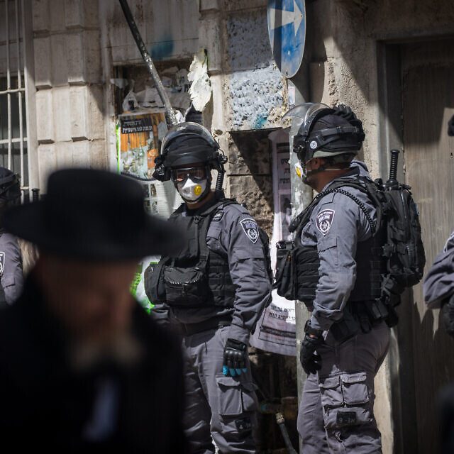 Israeli police officers seen during a raid on the ultra orthodox Jewish neighborhood of Meah Shearim, as they close shops and disperse public gatherings following the government decisions in an effort to contain the spread of the coronavirus. March 24, 2020. Photo by Yonatan Sindel/Flash90 