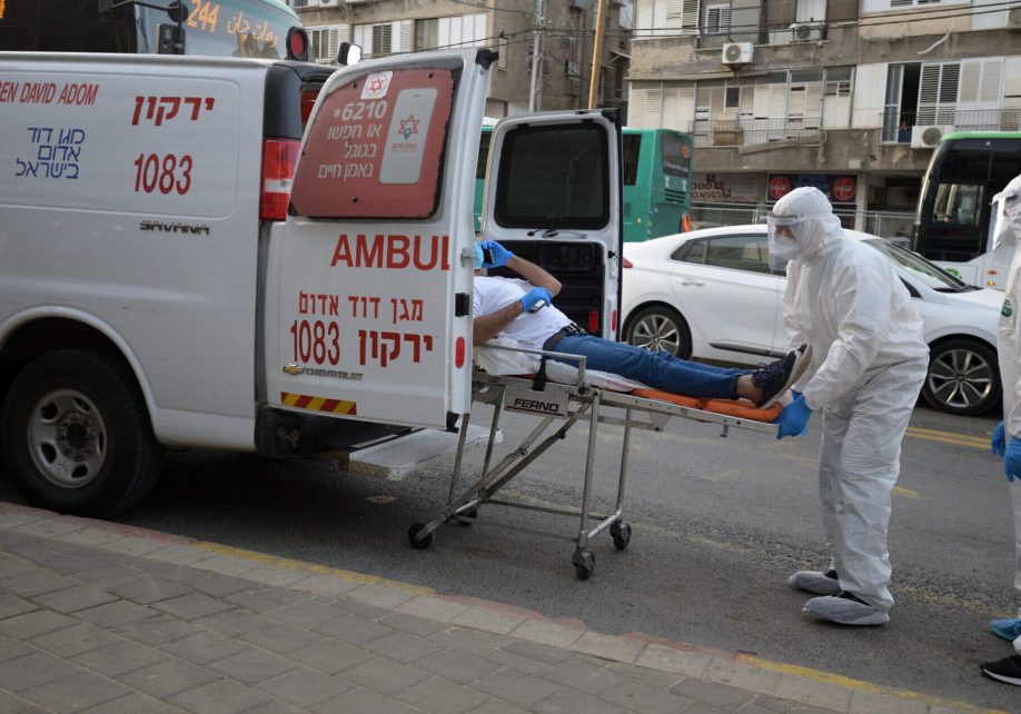 Israeli Magen David Adom medical team members transfer an Israeli man, suspected of being Covid-19 positive, in the Ultra-Orthodox Jewish city of Bnei Brak. Photo by Gili Yaari/Flash90
