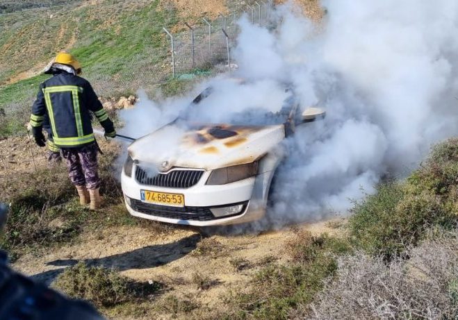 A car torched by the Hilltop Youth smoulders near the Palestinian village of Burin on January 21, 2022.