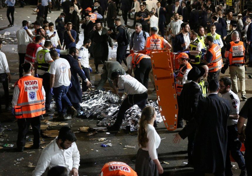 Israeli security officials and rescuers inspect the dead bodies of dozens of Ultra-Orthodox Jews who died during an event during Lag Ba'Omer; in Mount Meron, Israel (Credit: David Cohen/EPA)