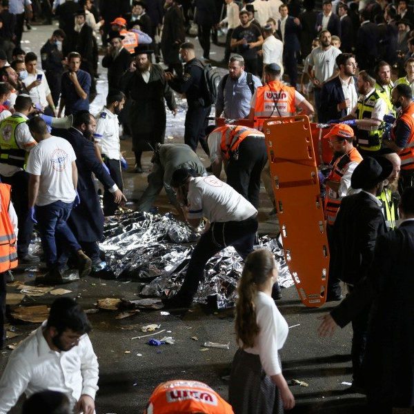 Israeli security officials and rescuers inspect the dead bodies of dozens of Ultra-Orthodox Jews who died during an event during Lag Ba'Omer; in Mount Meron, Israel (Credit: David Cohen/EPA)