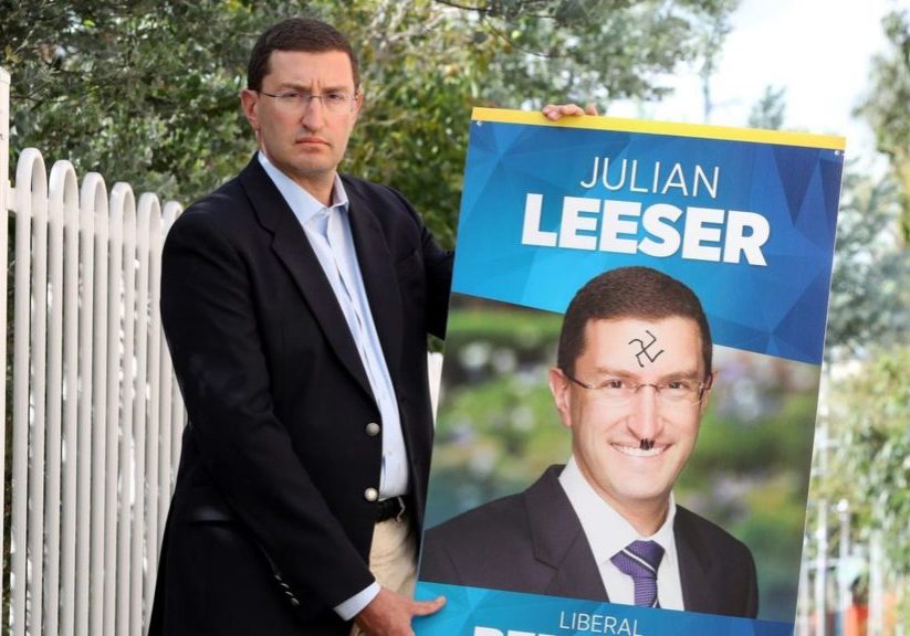 Julian Leeser MP with one of his vandalised campaign posters.