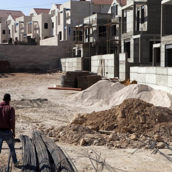 FILE - In this Sept. 16, 2014 file photo, a Palestinian laborer works at a construction site in the West Bank settlement of Maale Adumim, near Jerusalem.  (AP Photo/Dan Balilty, File)