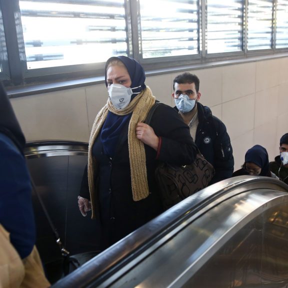 Iranian people wear protective masks to prevent contracting a coronavirus, as they climb an escalator in Teheran. Photo: WANA (West Asia News Agency)/Nazanin Tabatabaee via REUTERS